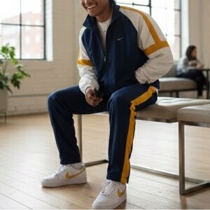 Dark blue and white sweatpants and jacket with yellow accents